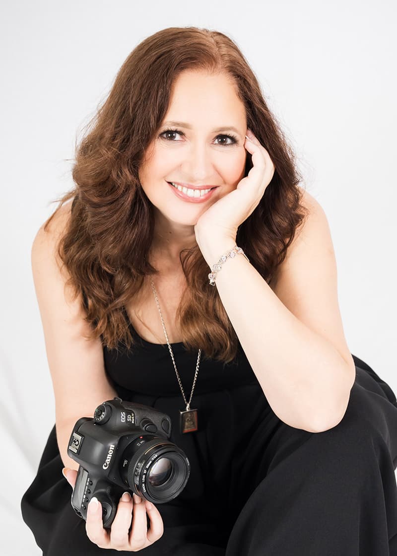 Janet Howard, founder of Studio Visibility, holding a camera